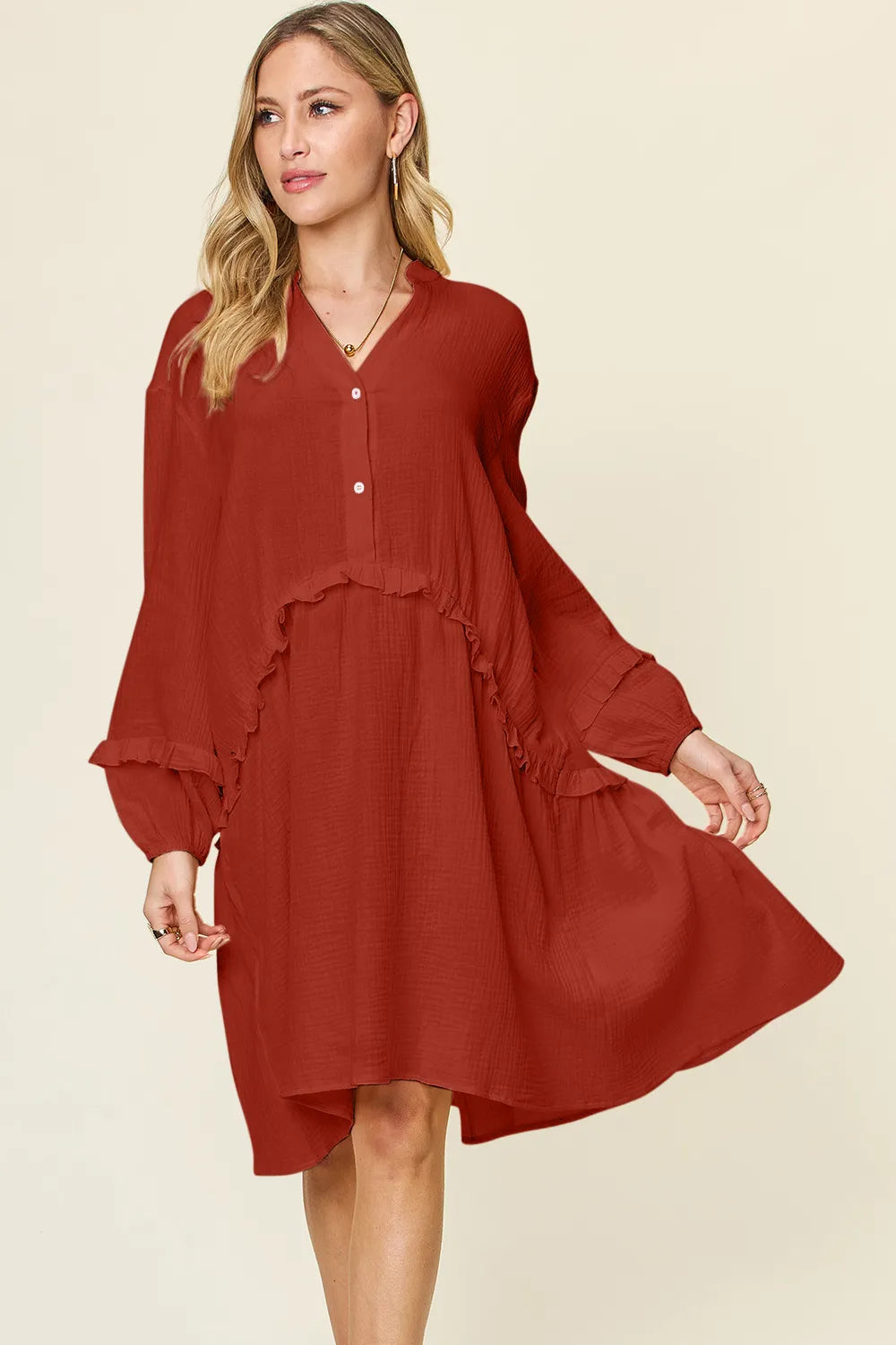 ​Model wearing the Season Prestige textured cotton half-button tiered dress in rust orange  