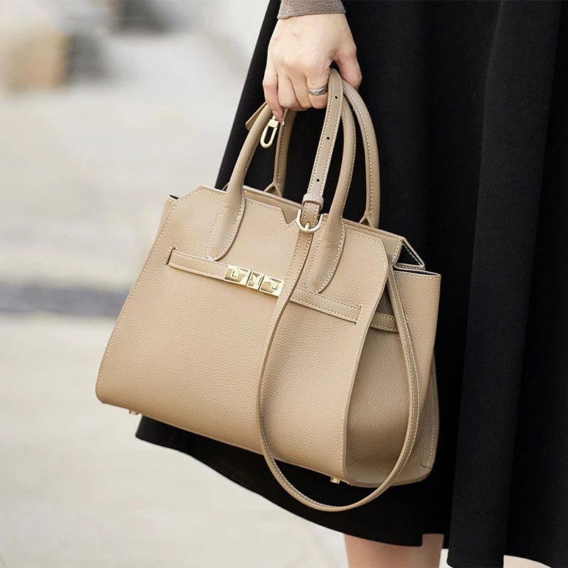 Season prestige Luxury top-grain leather structured tote bag with gold-tone belted clasp hardware on a whote background