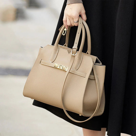 Season prestige Luxury top-grain leather structured tote bag with gold-tone belted clasp hardware on a whote background
